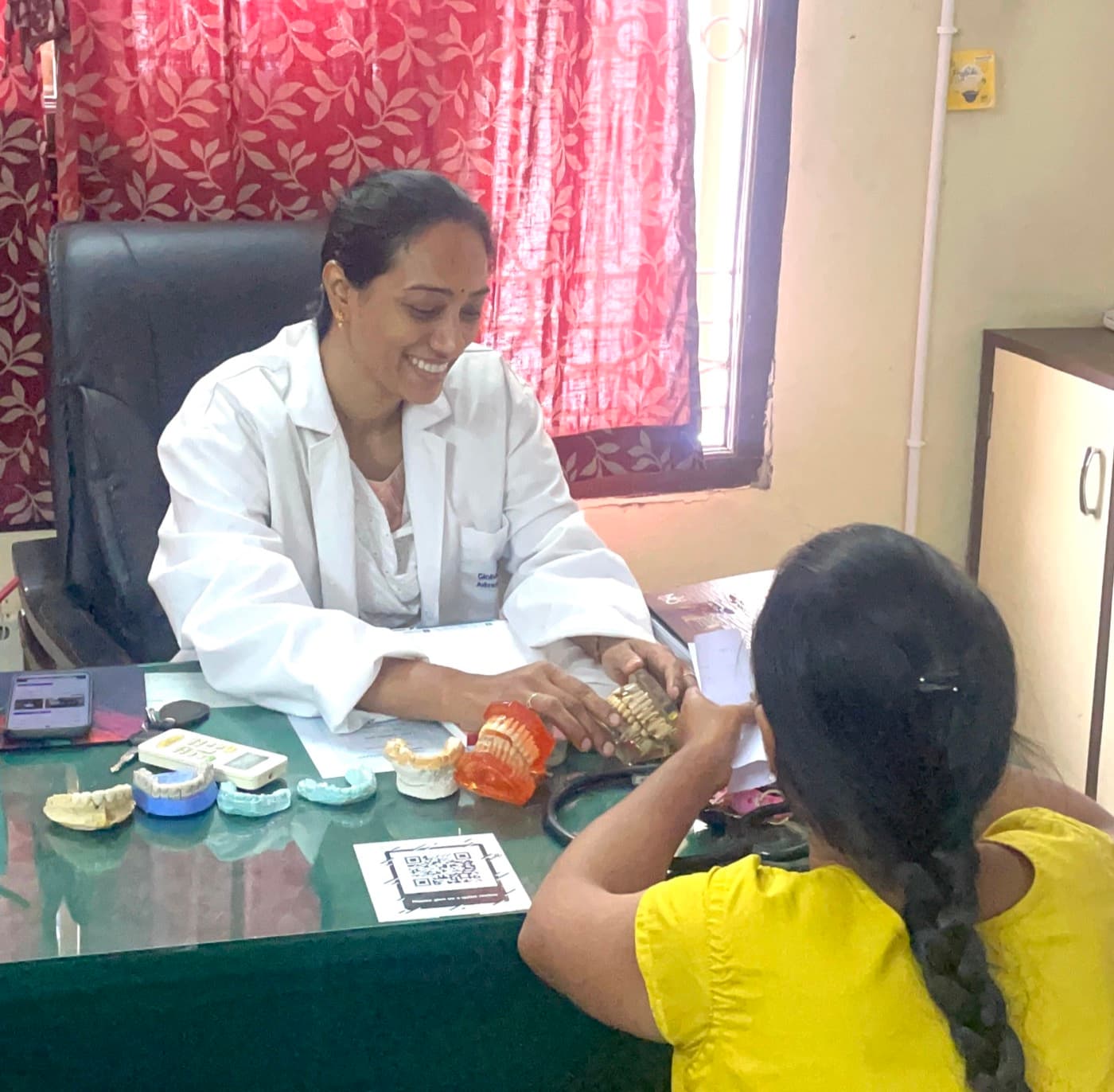 Dr. N.T. Mumtaz, experienced female dentist in Tirupati, consulting a patient at New Global Dental Clinic